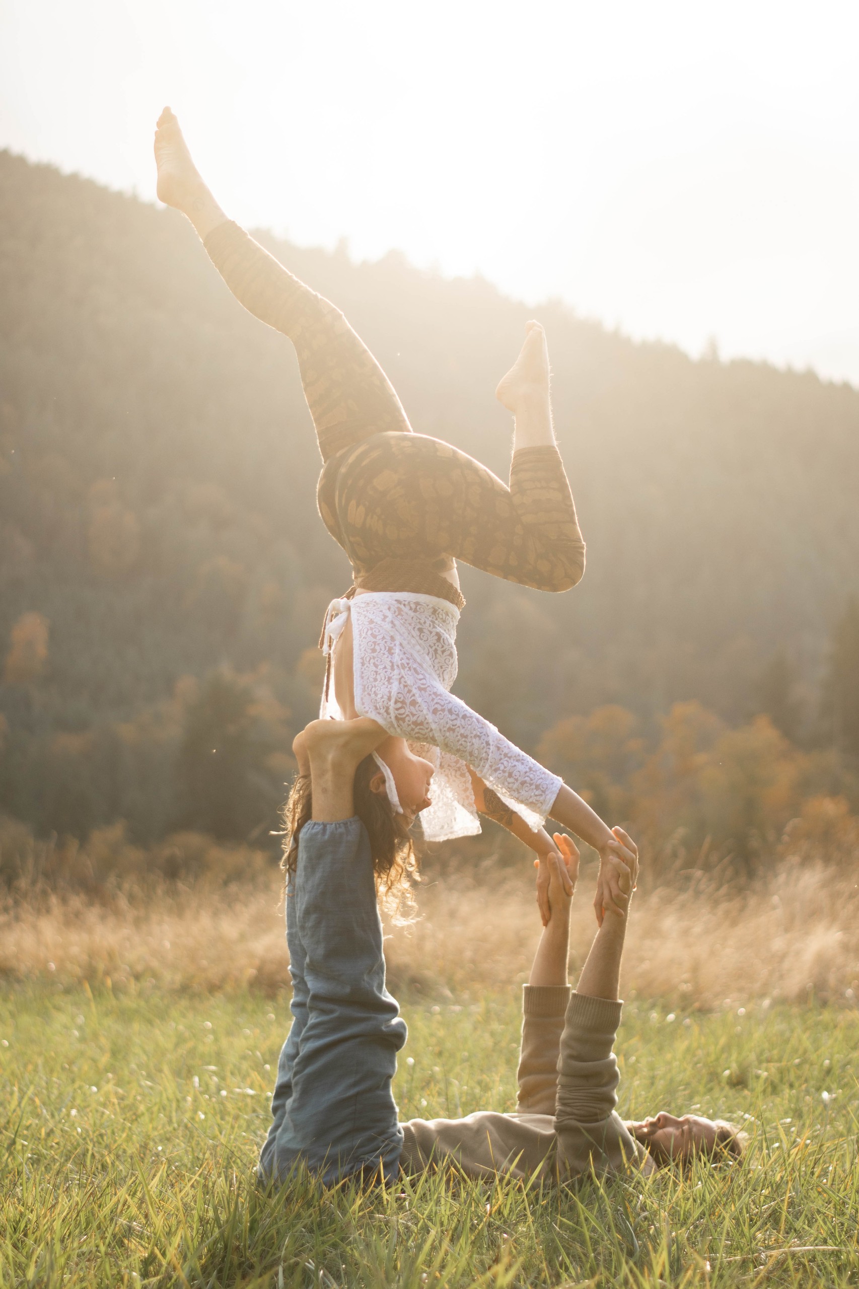 Couple acro yoga at sunset